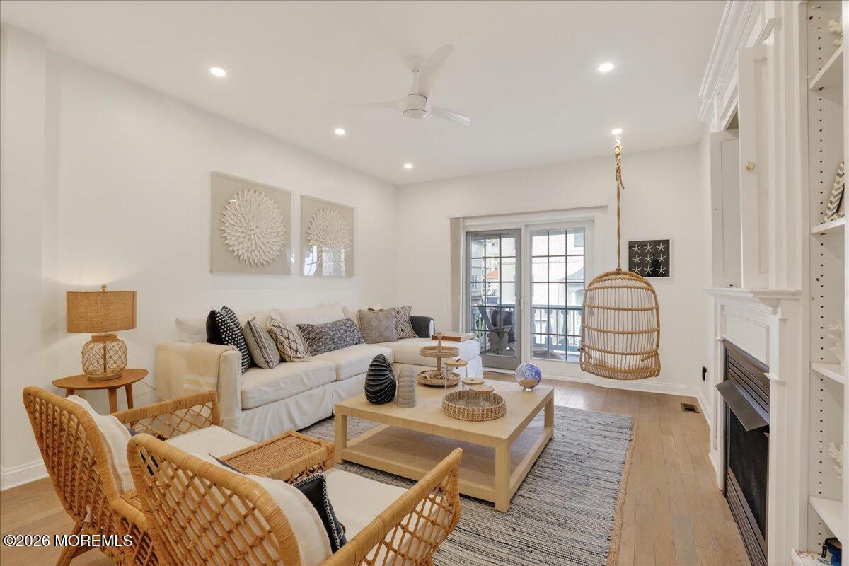 21 Riviera Drive Long Branch, NJ 07740 - Photo 4 of 64 a living room with furniture a fireplace and a flat screen tv