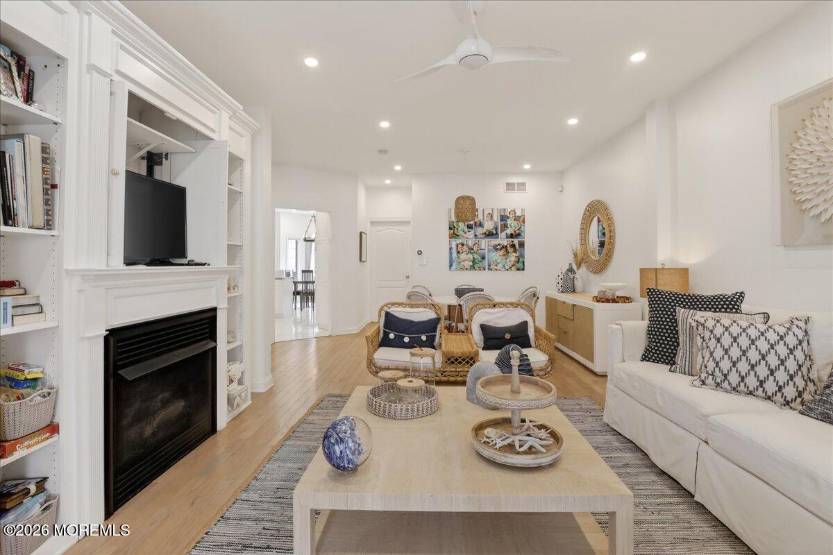 21 Riviera Drive Long Branch, NJ 07740 - Photo 6 of 64 a living room with furniture a fireplace and a flat screen tv