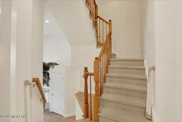 a view of entryway and hall with wooden floor