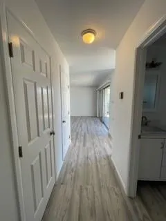 a view of a hallway with wooden floor