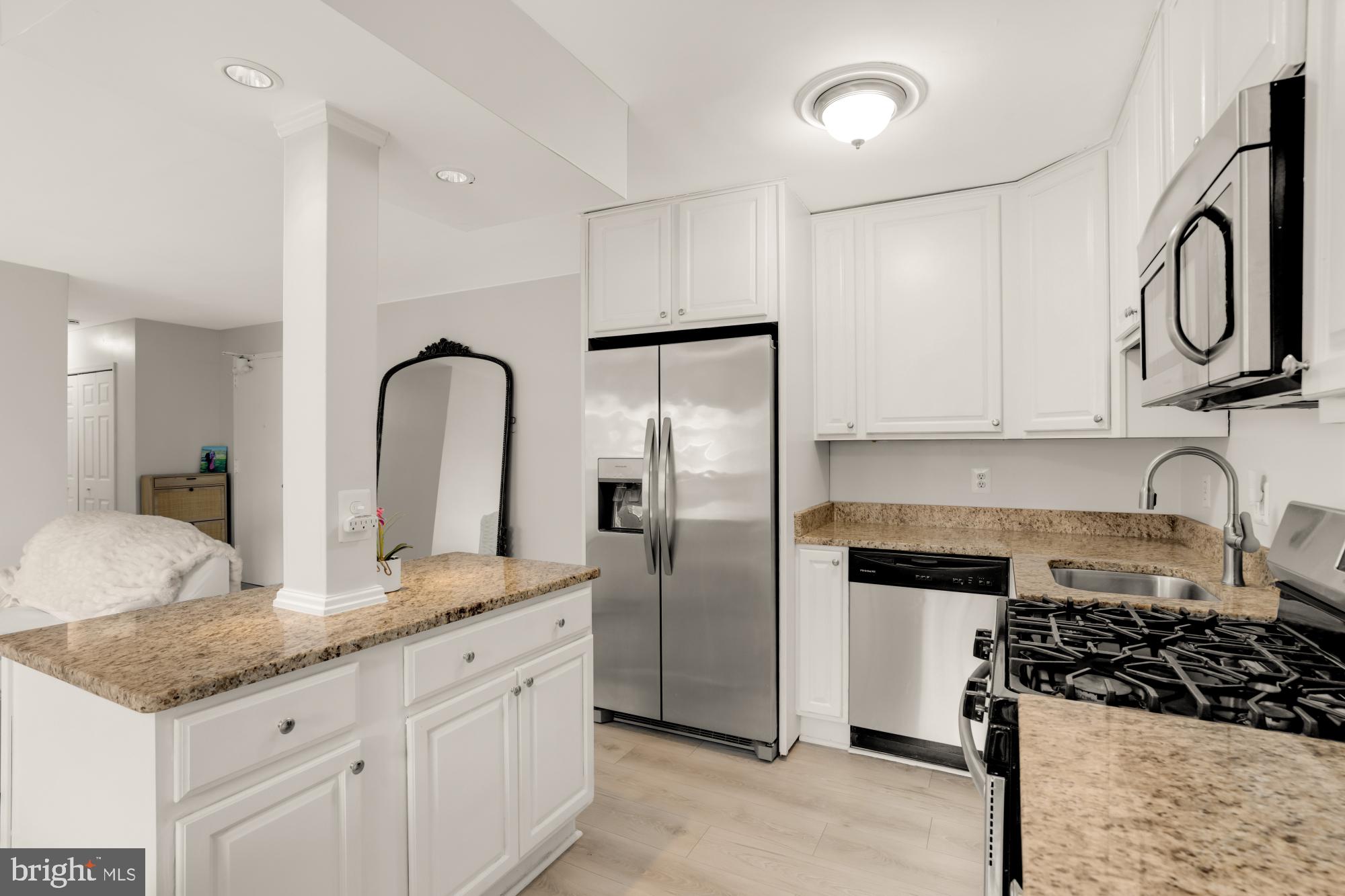 1200 South Arlington Ridge Road, Unit 507 Arlington, VA 22202 - Photo 15 of 30 a kitchen with granite countertop a sink stainless steel appliances and cabinets
