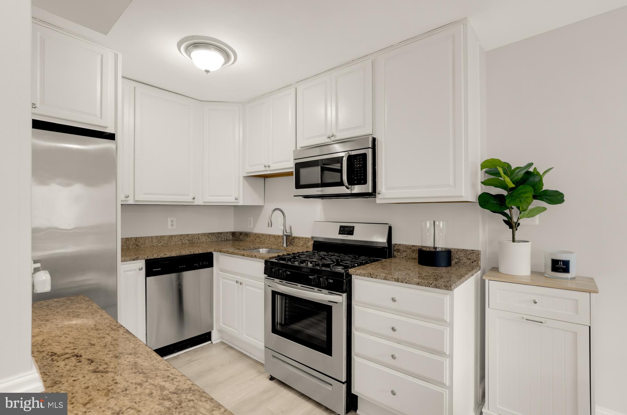 1200 South Arlington Ridge Road, Unit 507 Arlington, VA 22202 - Photo 17 of 30 a kitchen with white cabinets and appliances