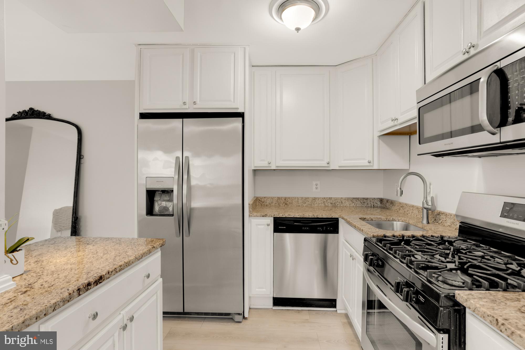 1200 South Arlington Ridge Road, Unit 507 Arlington, VA 22202 - Photo 18 of 30 a kitchen with granite countertop white cabinets and stainless steel appliances