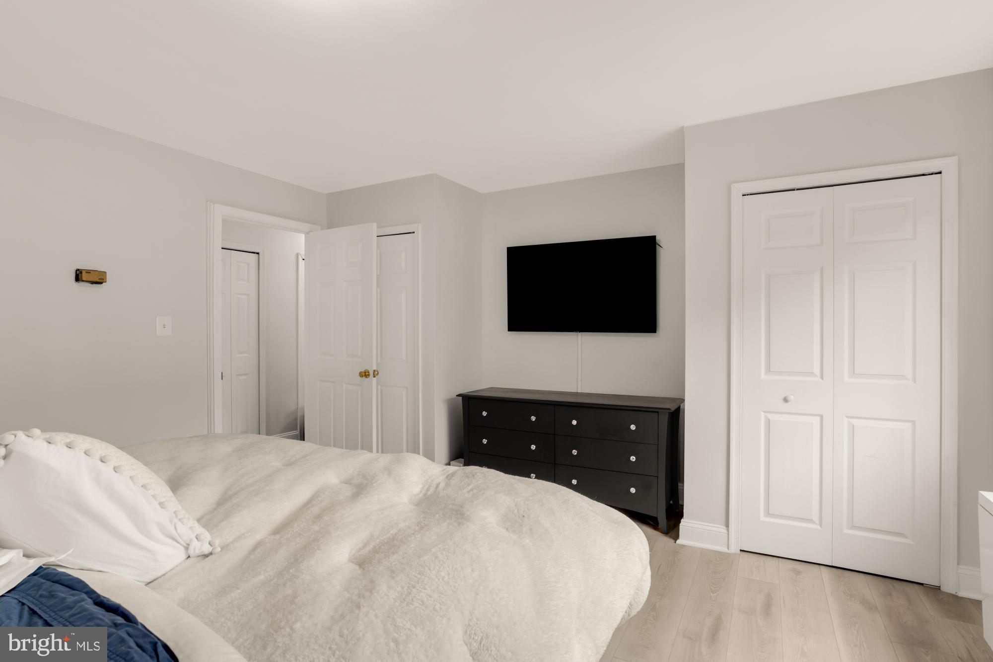 1200 South Arlington Ridge Road, Unit 507 Arlington, VA 22202 - Photo 24 of 30 a bedroom with a bed and a flat tv screen on dresser