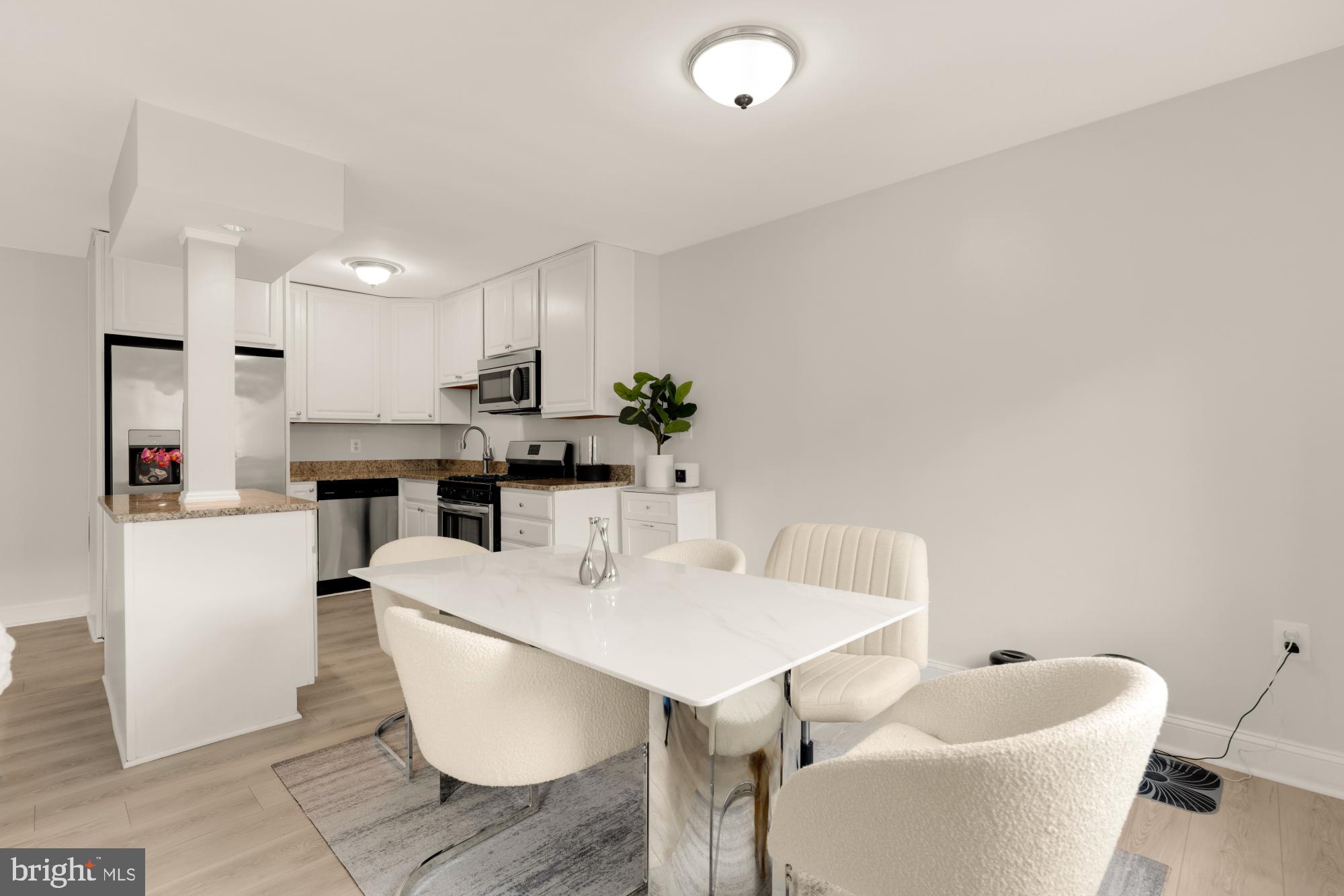 1200 South Arlington Ridge Road, Unit 507 Arlington, VA 22202 - Photo 4 of 30 a living room with stainless steel appliances furniture a dining table and chairs