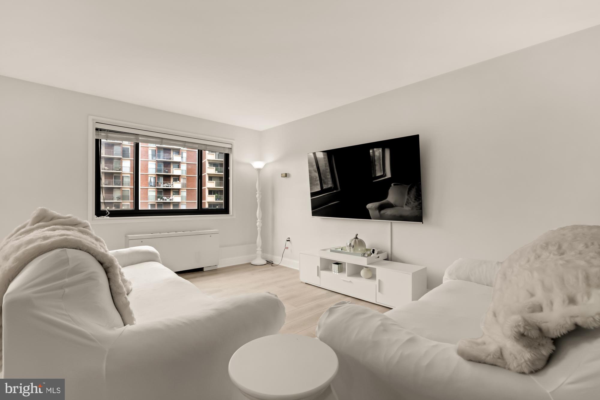 1200 South Arlington Ridge Road, Unit 507 Arlington, VA 22202 - Photo 9 of 30 a living room with furniture and a flat screen tv