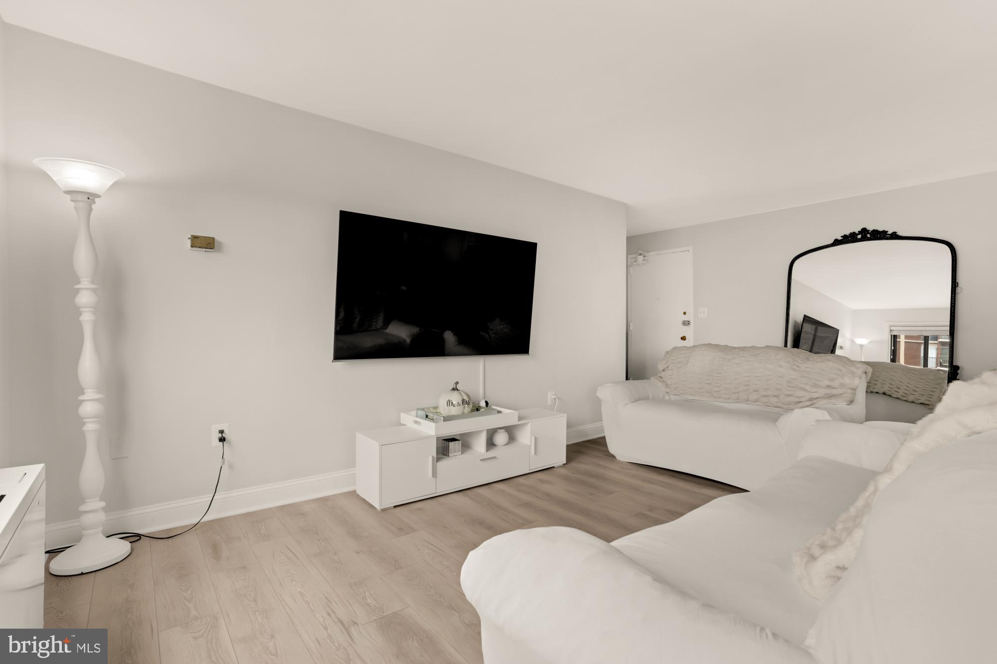 1200 South Arlington Ridge Road, Unit 507 Arlington, VA 22202 - Photo 10 of 30 a living room with furniture and a flat screen tv