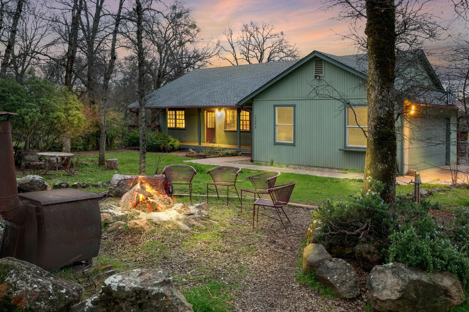 17293 Perimeter Road Grass Valley, CA 95949 - Photo 1 of 1 a view of a house with a yard patio and a fire pit