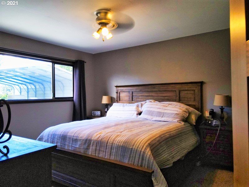 1335 Southwest 41st Street Pendleton, OR 97801 - Photo 11 of 27 a bedroom with a bed and a chandelier