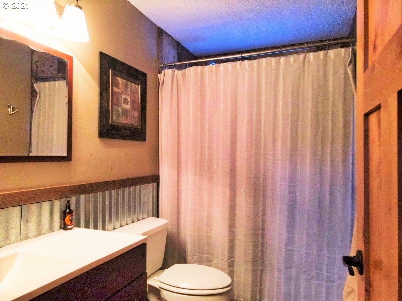 1335 Southwest 41st Street Pendleton, OR 97801 - Photo 14 of 27 a bathroom with a sink a toilet and shower curtain