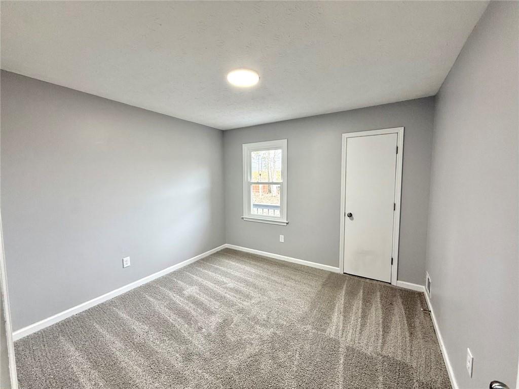 3851 Riding Woods Court Powder Springs, GA 30127 - Photo 14 of 32 a view of an empty room with a window