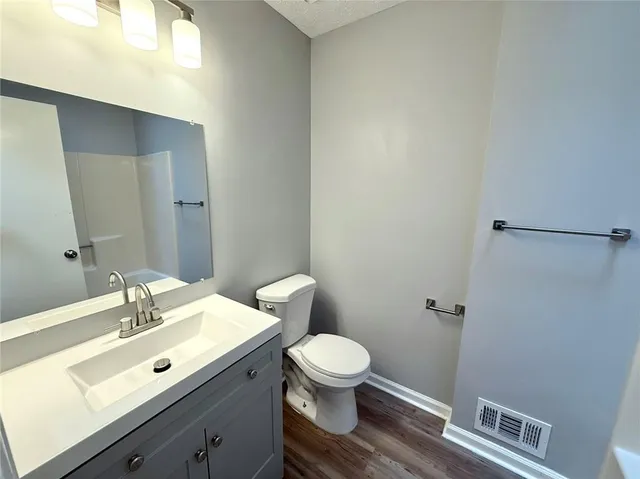 a bathroom with a sink mirror and toilet
