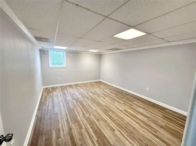 a view of a room with wooden floor