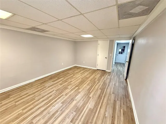 a view of a room with wooden floor and entryway