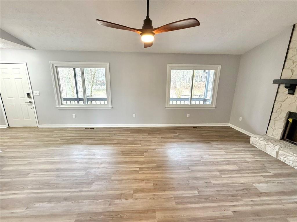 3851 Riding Woods Court Powder Springs, GA 30127 - Photo 5 of 32 an empty room with wooden floor and windows
