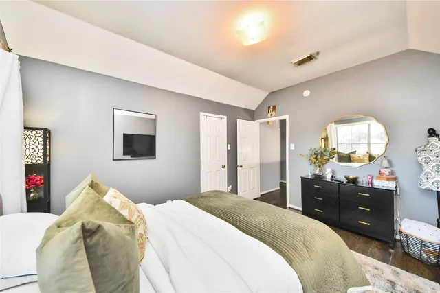 a bedroom with a bed and a dresser