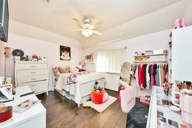 a bed room with a bed a flat screen tv and a couch