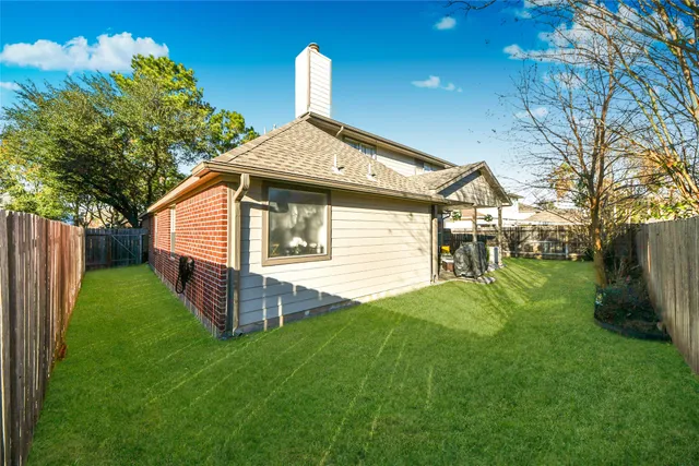a view of a house with a yard and sitting area