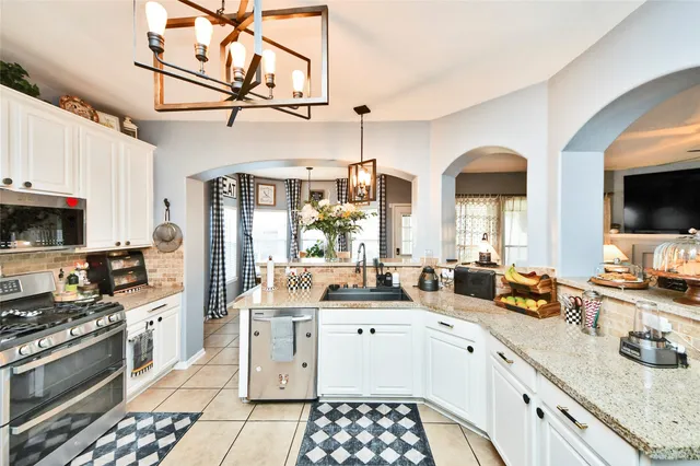 a kitchen with stainless steel appliances a sink stove and refrigerator