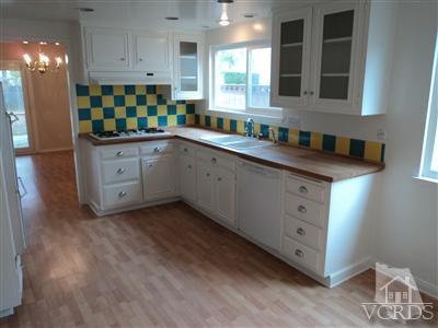 19 Kanan Road Oak Park, CA 91377 - Photo 3 of 12 a kitchen with granite countertop white cabinets and window