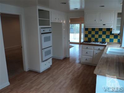 19 Kanan Road Oak Park, CA 91377 - Photo 4 of 12 a kitchen with stainless steel appliances granite countertop a refrigerator and a stove top oven