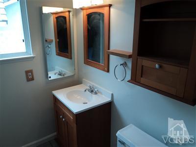 19 Kanan Road Oak Park, CA 91377 - Photo 7 of 12 a bathroom with a toilet sink and mirror