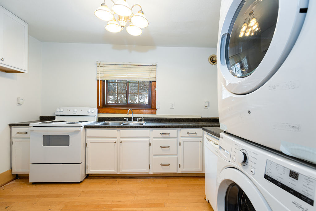 809 Franklin Street Galena, IL 61036 - Photo 12 of 28 a utility room with granite countertop a sink a washer and dryer