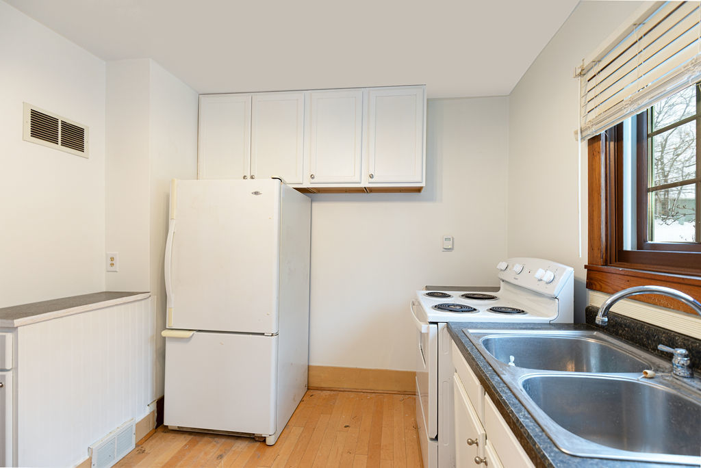 809 Franklin Street Galena, IL 61036 - Photo 14 of 28 a kitchen with a refrigerator sink and cabinets