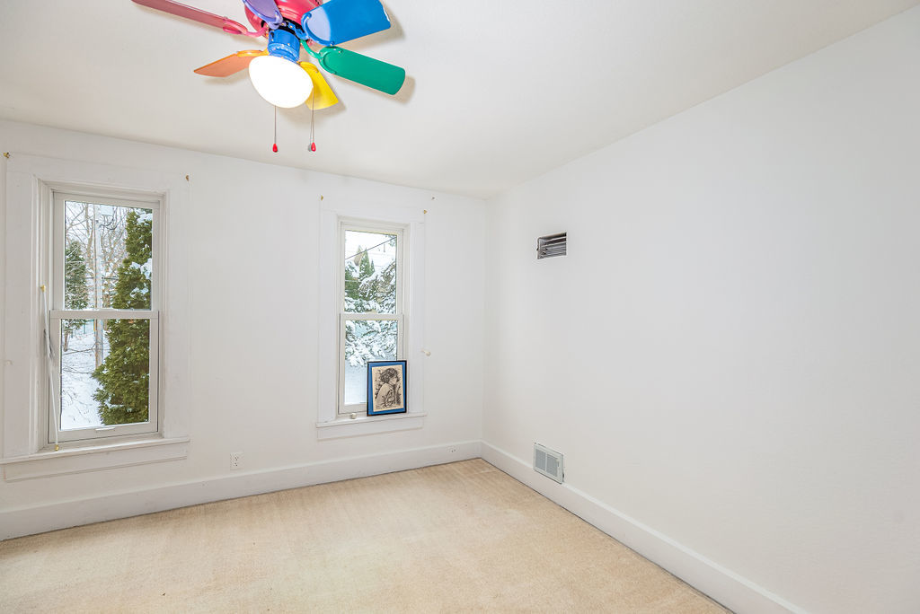 809 Franklin Street Galena, IL 61036 - Photo 21 of 28 an empty room with windows and chandelier fan