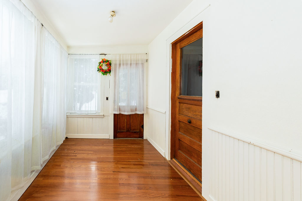 809 Franklin Street Galena, IL 61036 - Photo 5 of 28 a view of a hallway view with wooden floor and staircase