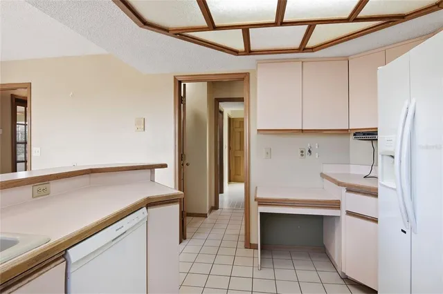 a bathroom with a double vanity sink a mirror a bathtub and next to a window