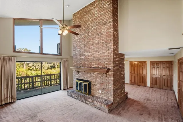 a view of a livingroom with a fireplace and a window