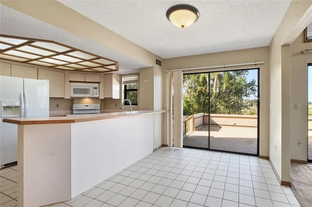 a kitchen with granite countertop a sink and a stove top oven