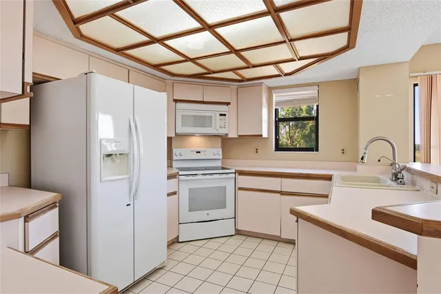 a kitchen with stainless steel appliances a sink cabinets and a refrigerator