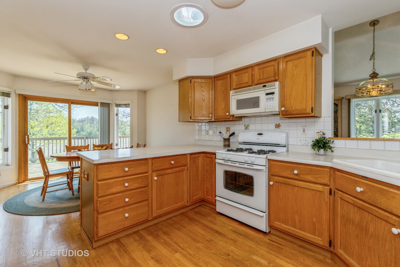 16943 West State Line Road Zion, IL 60099 - Photo 7 of 26 a kitchen with a stove a sink and a microwave