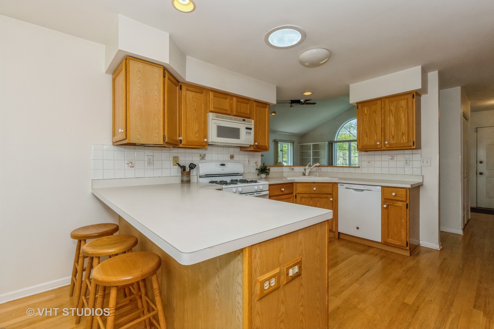 16943 West State Line Road Zion, IL 60099 - Photo 8 of 26 a kitchen with stainless steel appliances a sink a stove a refrigerator cabinets and a counter top space