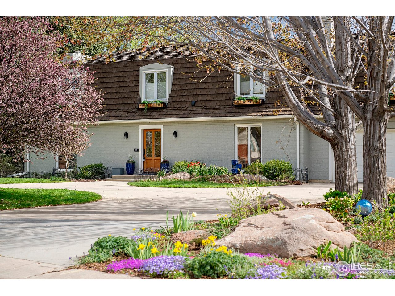 a front view of a house with a yard and a garage