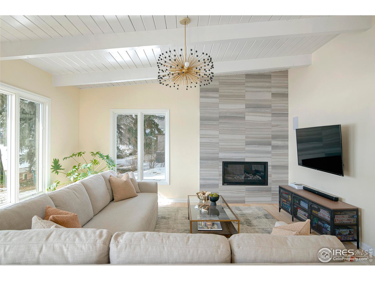 7034 Indian Peaks Trail Boulder, CO 80301 - Photo 12 of 40 a living room with furniture a flat screen tv and a fireplace
