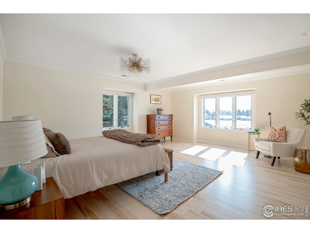 7034 Indian Peaks Trail Boulder, CO 80301 - Photo 22 of 40 a bedroom with a bed and wooden floor