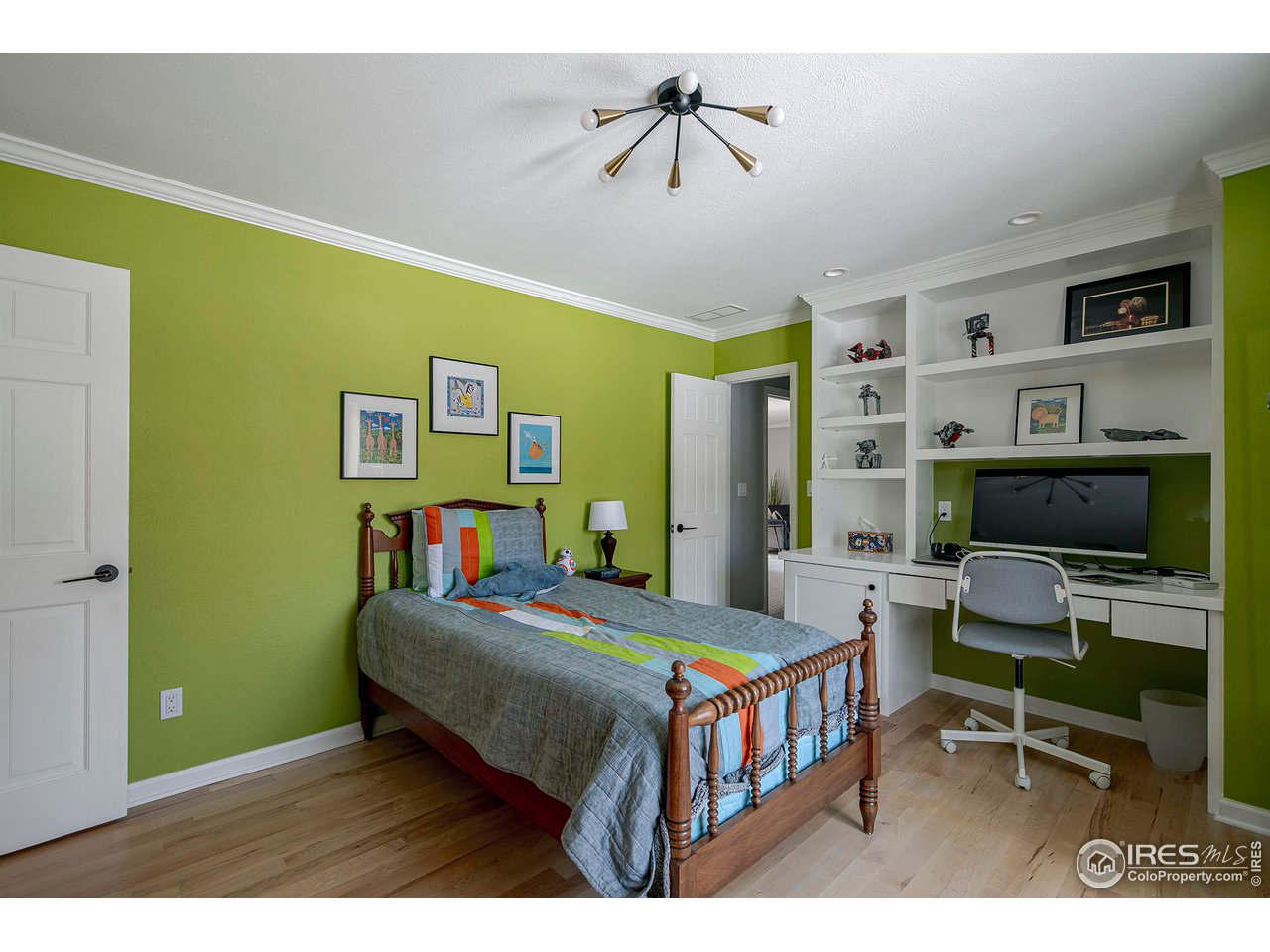 7034 Indian Peaks Trail Boulder, CO 80301 - Photo 28 of 40 a bedroom with a bed and a bookshelf