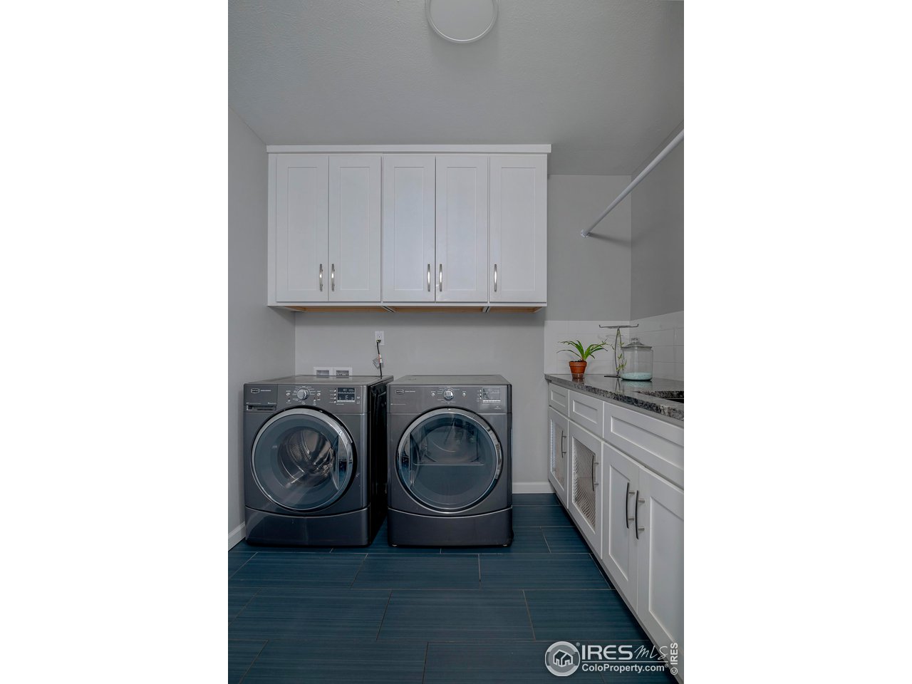 7034 Indian Peaks Trail Boulder, CO 80301 - Photo 36 of 40 a utility room with sink dryer and washer