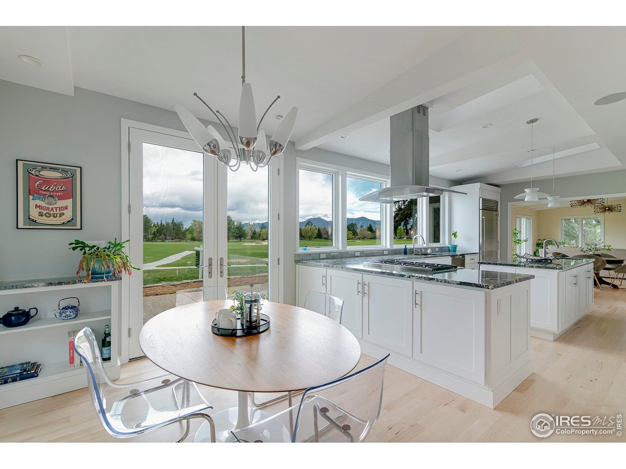 7034 Indian Peaks Trail Boulder, CO 80301 - Photo 8 of 40 a kitchen with stainless steel appliances granite countertop a stove a sink a dining table and chairs