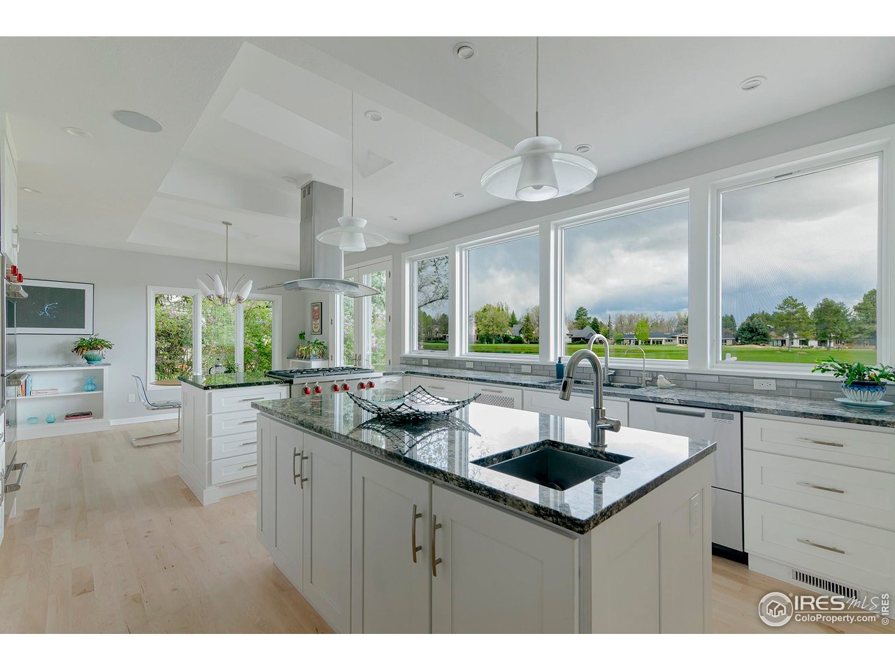 7034 Indian Peaks Trail Boulder, CO 80301 - Photo 9 of 40 a kitchen with kitchen island a sink appliances and a large window