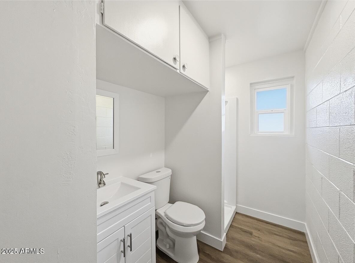 513 East Hatcher Road, Unit 6 Phoenix, AZ 85020 - Photo 3 of 8 a bathroom with a sink toilet and wooden floor