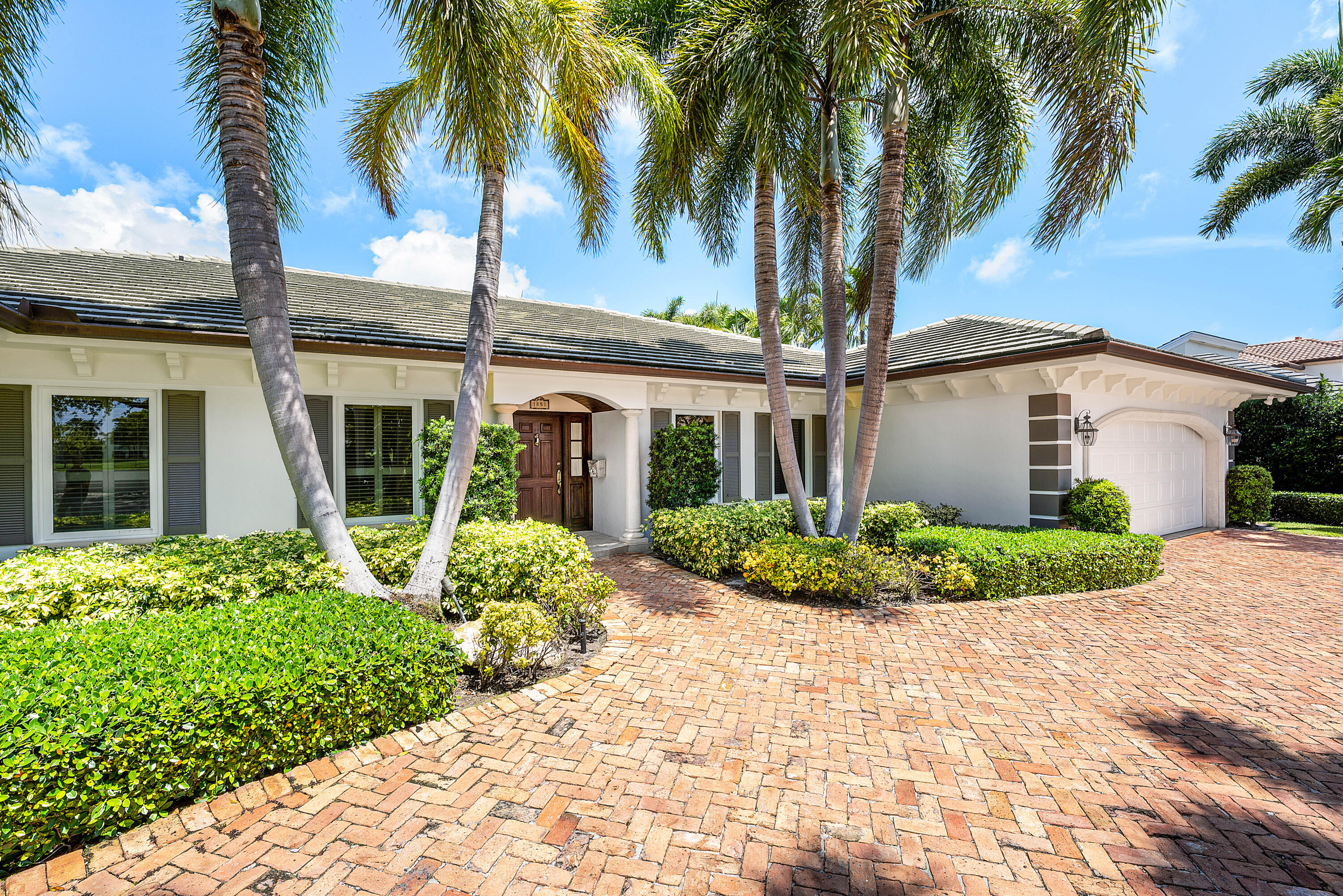 1851 Thatch Palm Drive Boca Raton, FL 33432 - Photo 5 of 70 a front view of a house with a garden