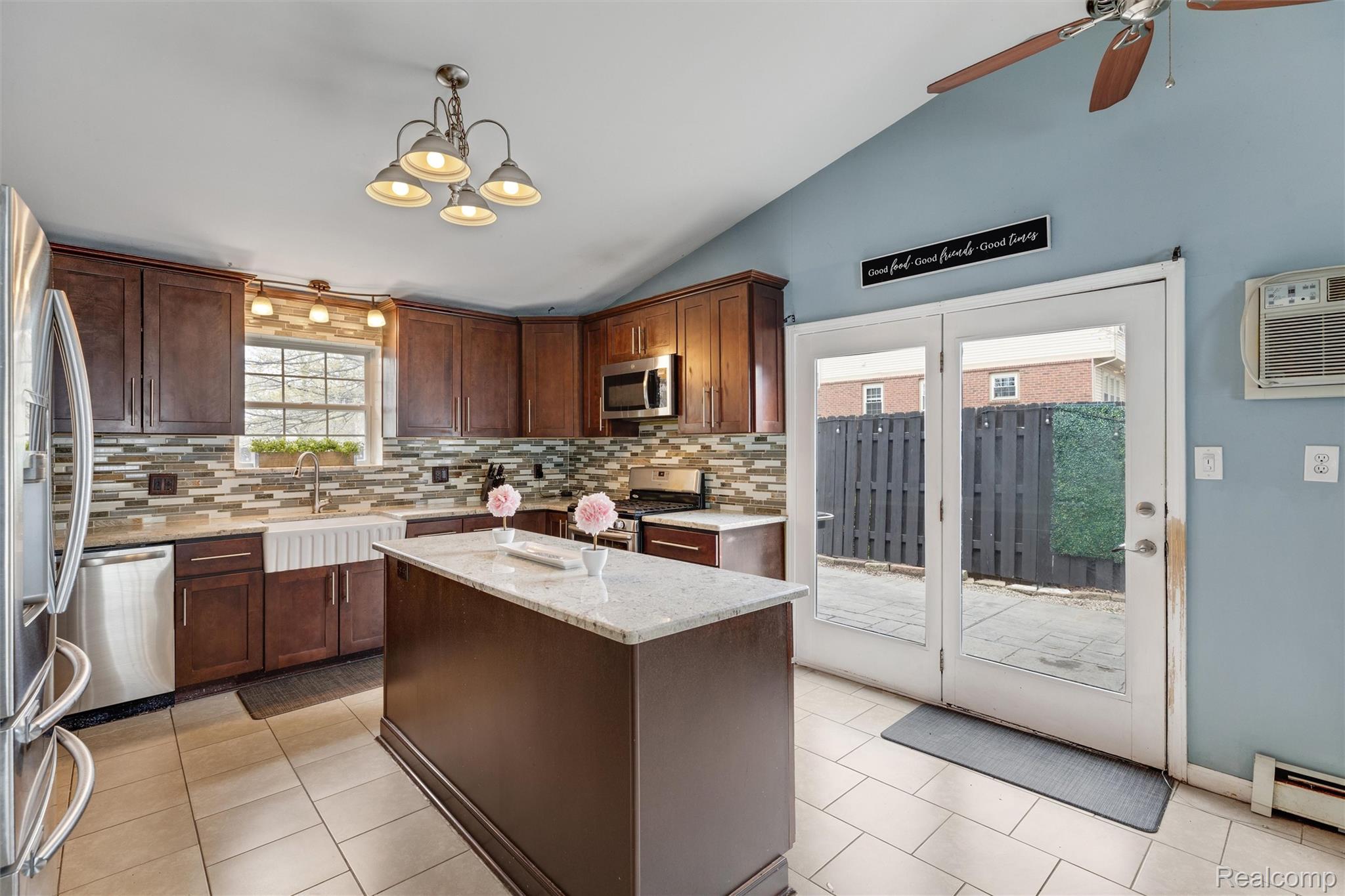 415 Leon Road Walled Lake, MI 48390 - Photo 17 of 47 Kitchen featuring wood cabinetry, stainless steel appliances, a white farmhouse sink, and a central island with a light-toned countertop