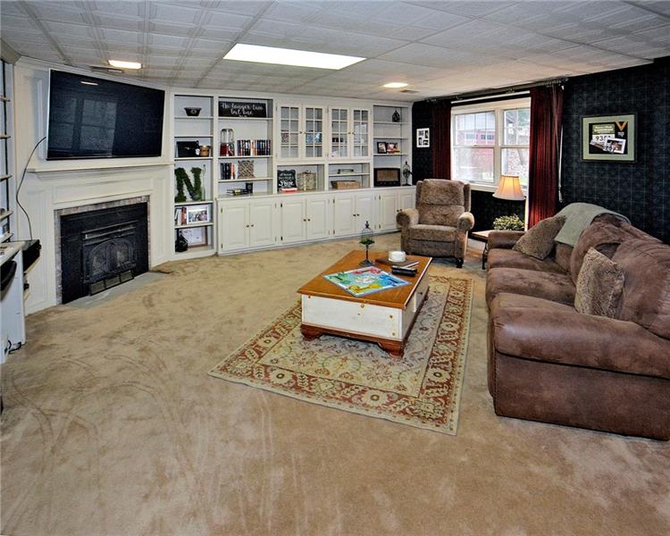 111 McDermott Road Trafford, PA 15085 - Photo 22 of 25 Family room on main entrance level. This level could be turned into an entry-level guest suite! Additional side entrance with a concrete patio to this oversized room. Entry level boasts a full bath, laundry/utility room, 29x18 FR that could be split to accommodate another bedroom and/or kitchenette.