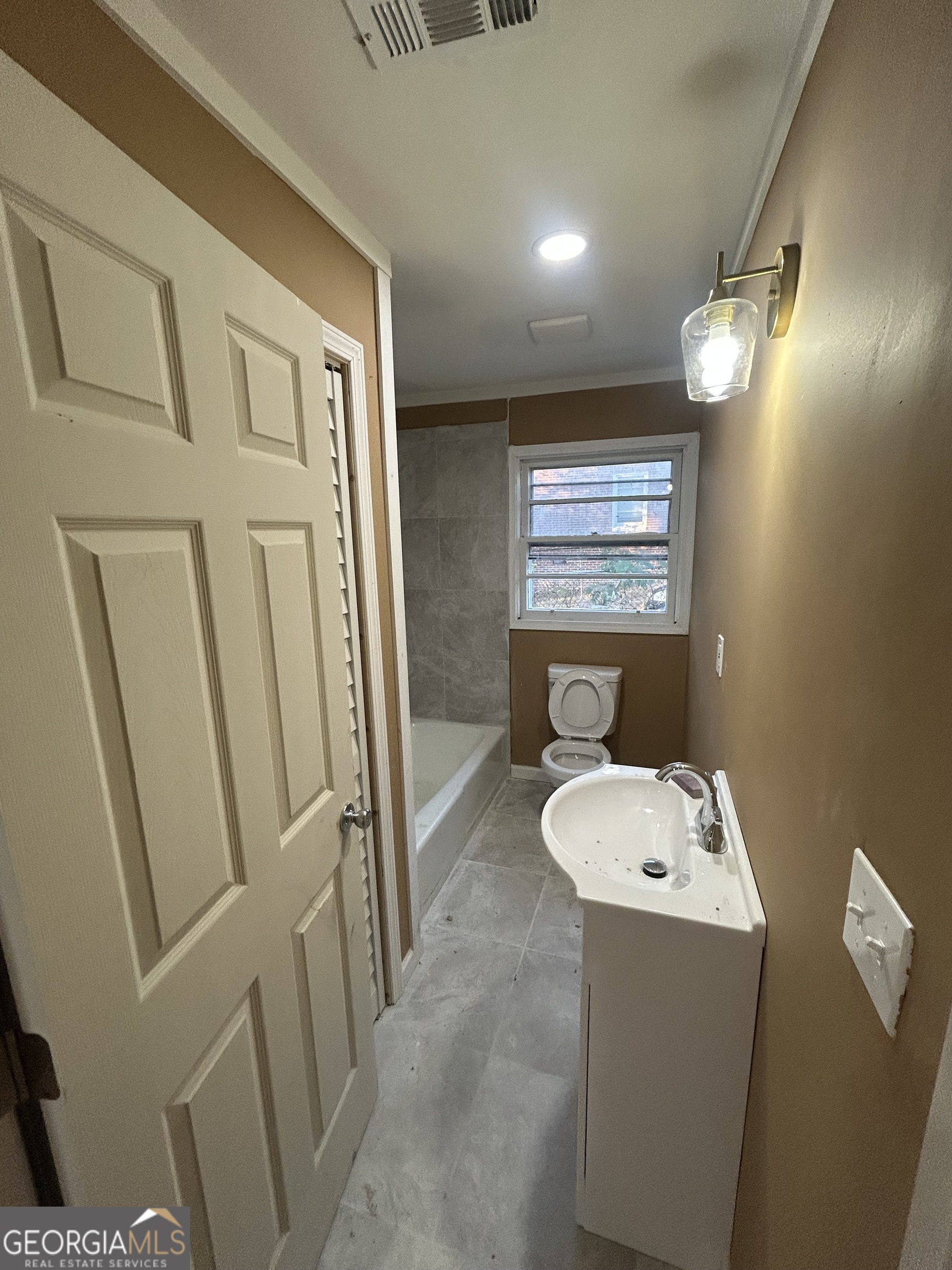 1545 Anthony Road Macon, GA 31204 - Photo 4 of 8 a bathroom with a sink toilet and shower