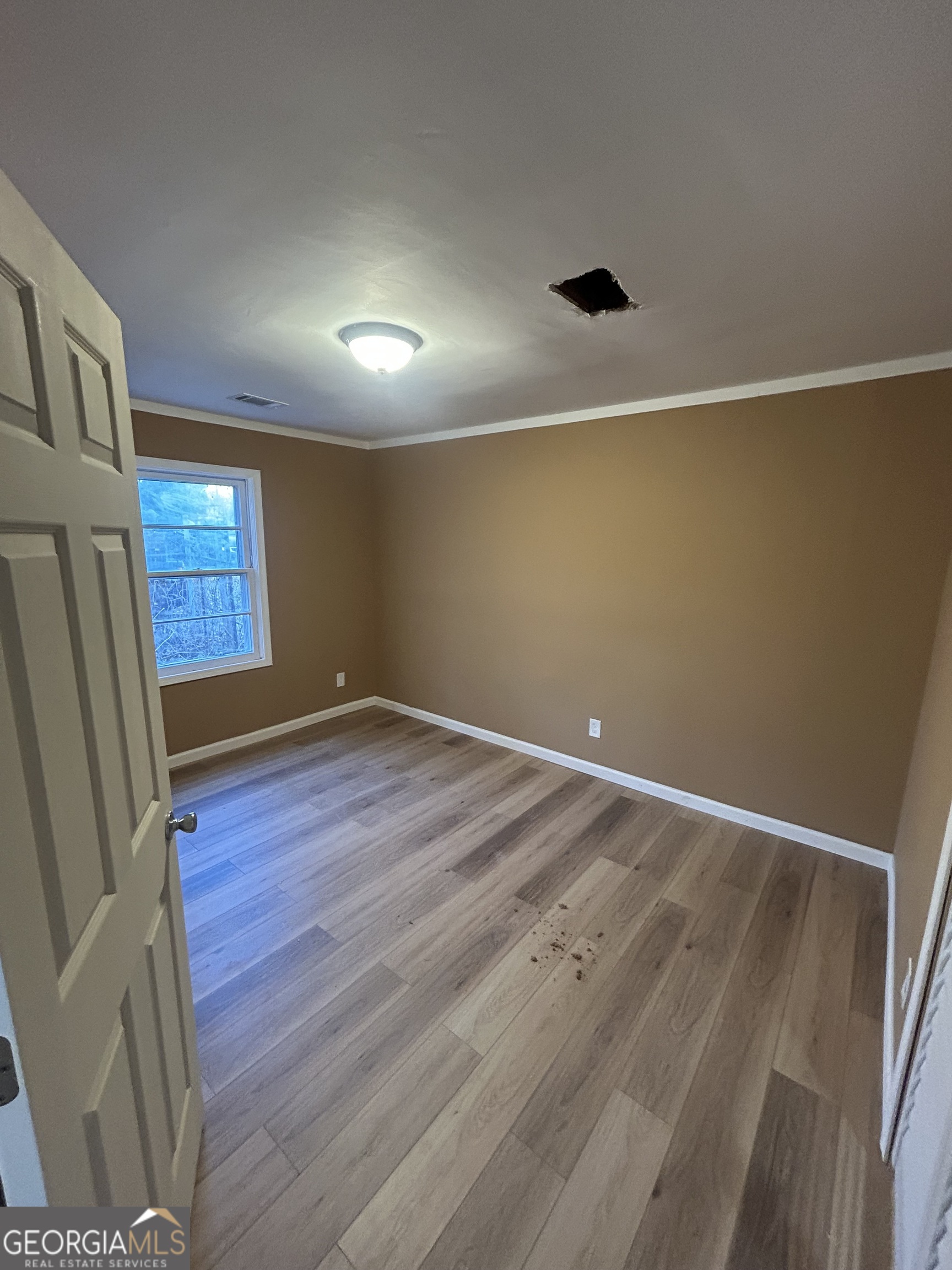 1545 Anthony Road Macon, GA 31204 - Photo 8 of 8 an empty room with wooden floor and windows