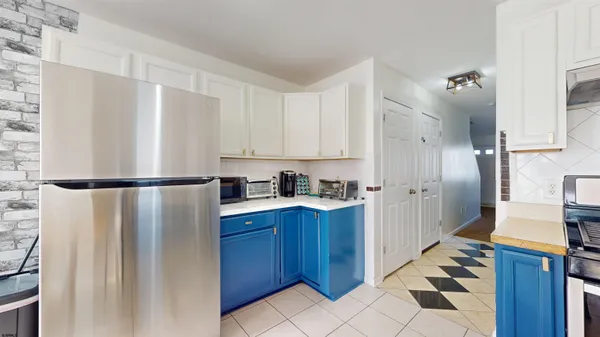 a kitchen with stainless steel appliances granite countertop a sink dishwasher a stove and a microwave oven with cabinets